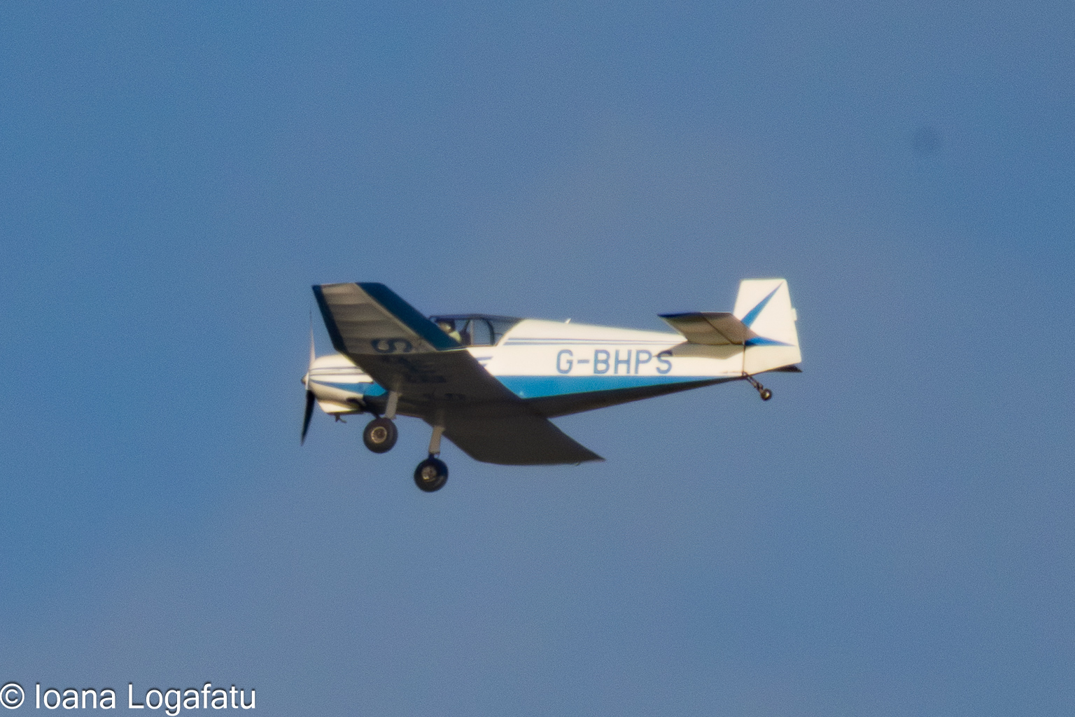 Vintage airplane soaring across a clear sky